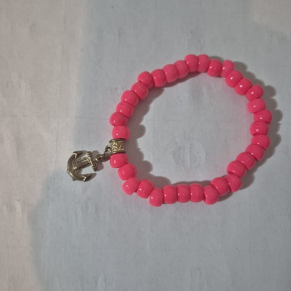 Pink bead bracelet with gold anchor