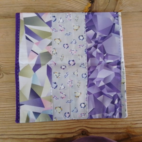 Cushion cover with an abstract purple theme and an envelope closure.
