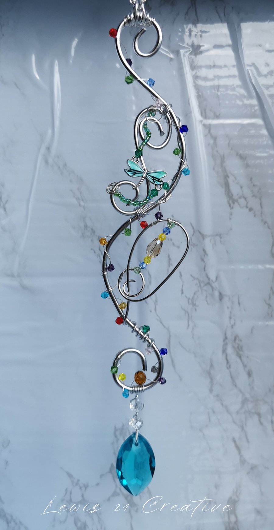 S shaped silver wire suncatcher with colourful beads and dragonfly