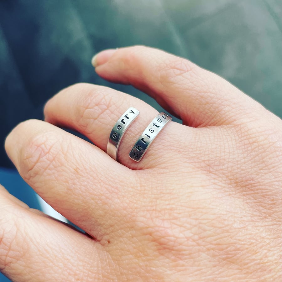 Festive stamped wrap ring with hidden swear