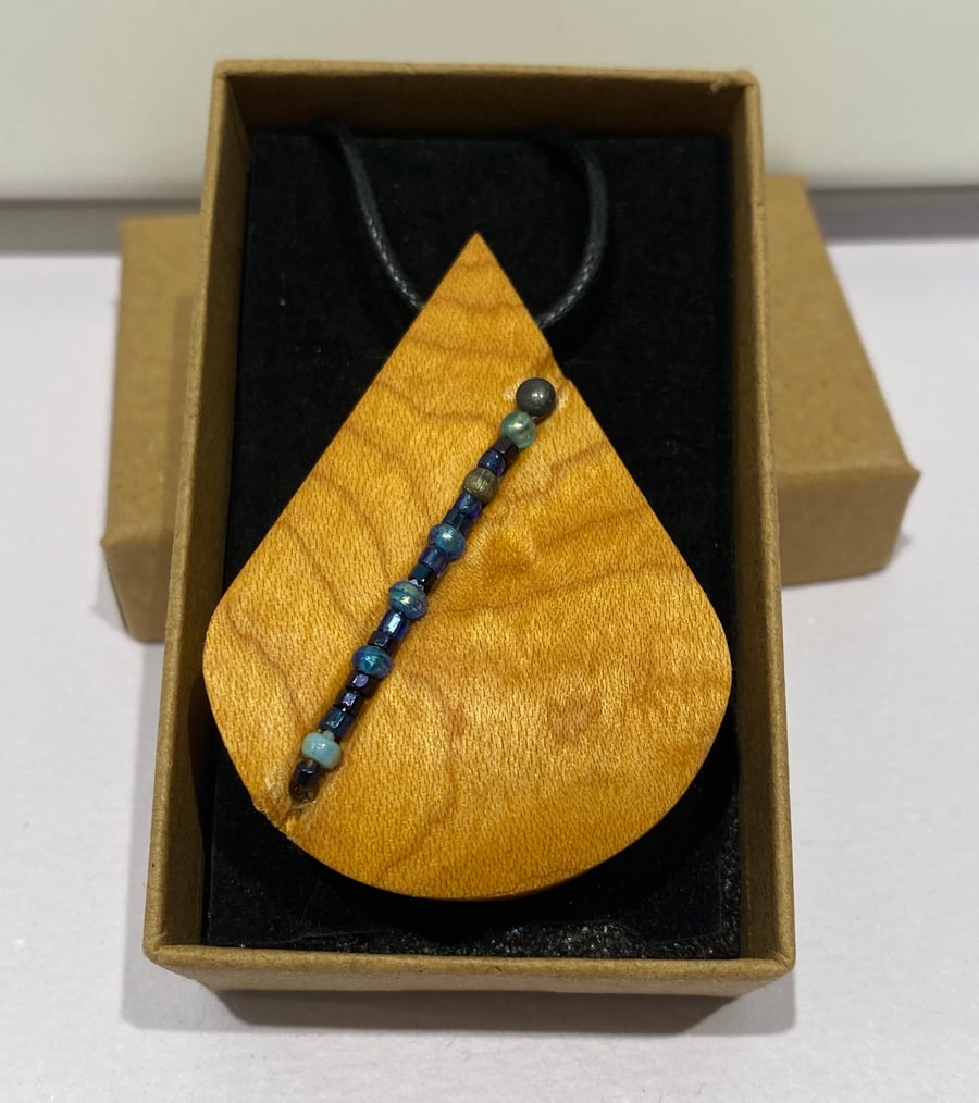 Wooden pendant necklace on leather thong