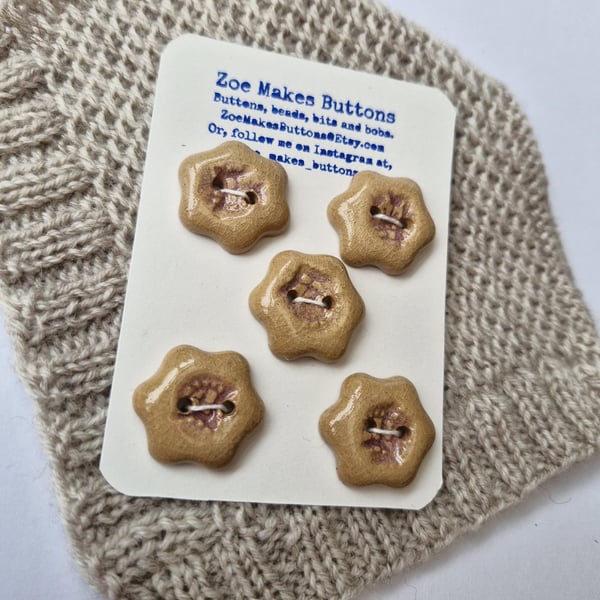 A Set of light brown and lilac handmade ceramic buttons.
