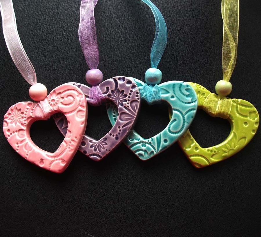 Set of four bright ceramic hearts
