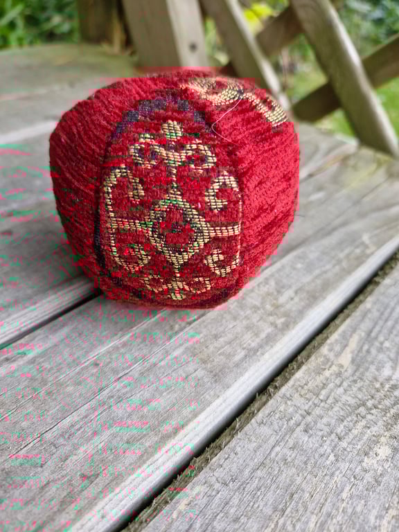 Small, decorative, christmas, red and gold fabric bauble ball.
