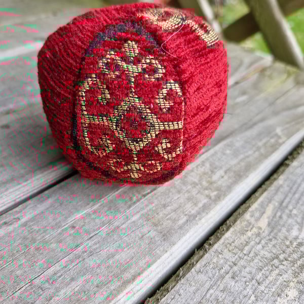 Small, decorative, christmas, red and gold fabric bauble ball.