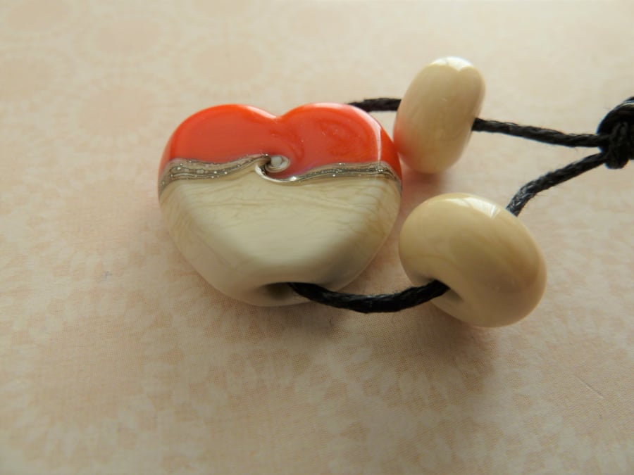 orange and ivory lampwork heart bead