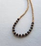 Onyx and gold glass beaded necklace, 16 to 18 inches