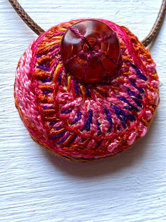 Autumnal hand embroidered pendant in warm pinks 