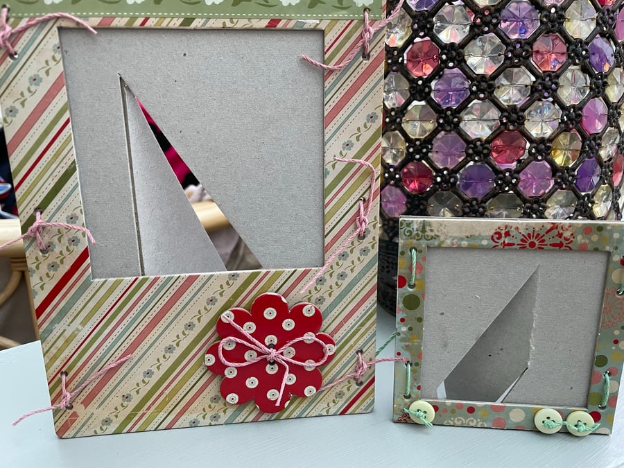 A pair of matching quirky chipboard photo frames
