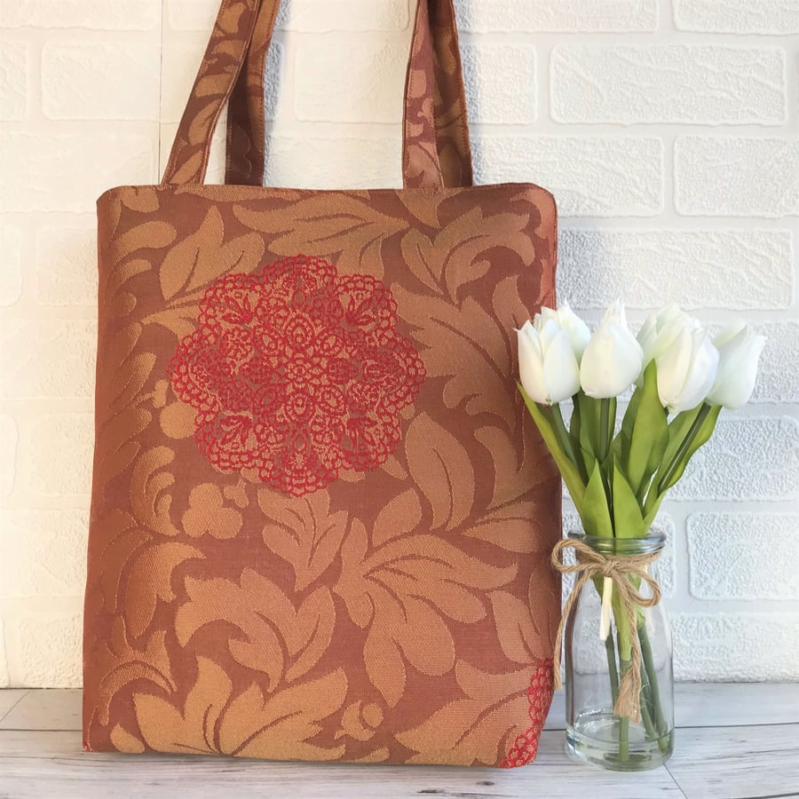 Terracotta leafy tote bag with red flower