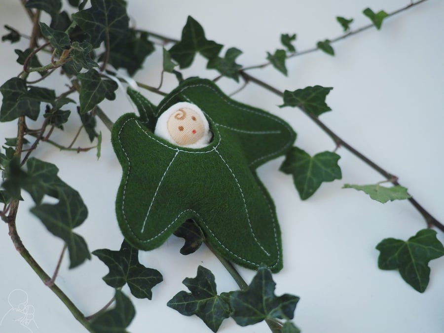Tiny woodland fairy in an ivy leaf