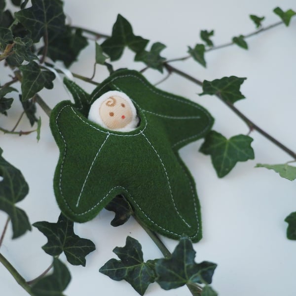 Tiny woodland fairy in an ivy leaf