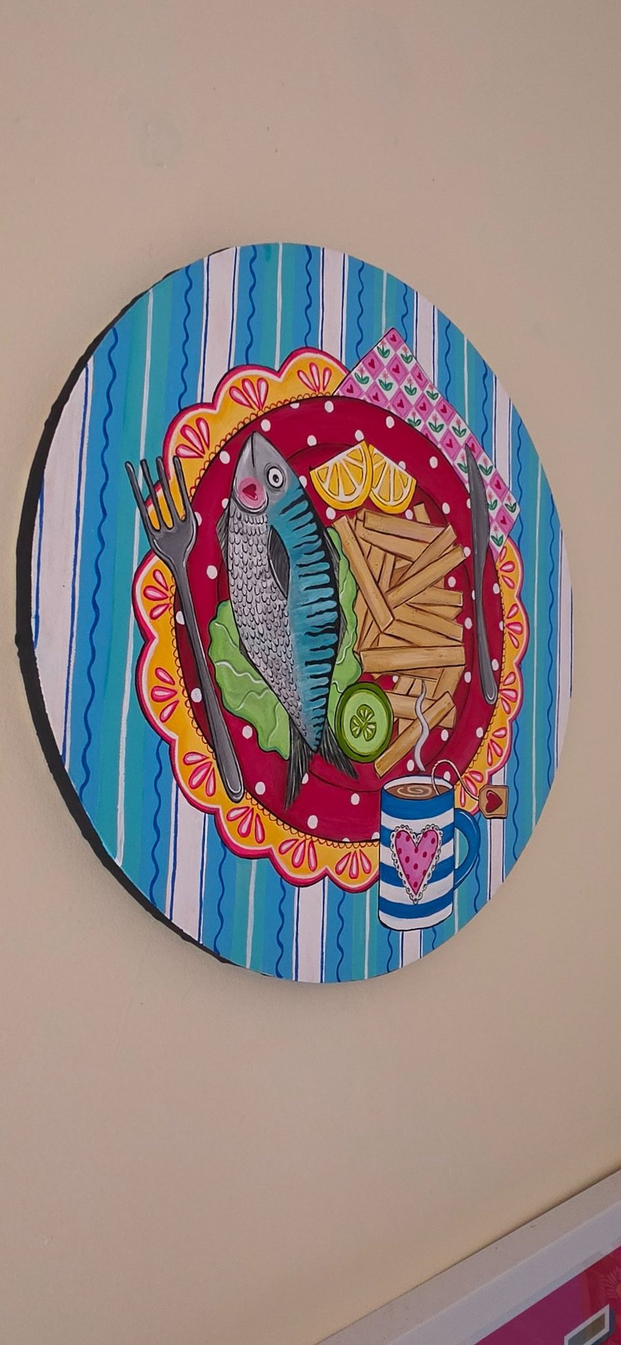 Original round canvas of fish and chips supper with a cup of tea. 