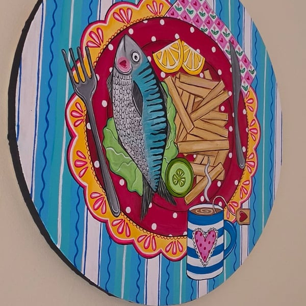 Original round canvas of fish and chips supper with a cup of tea. 
