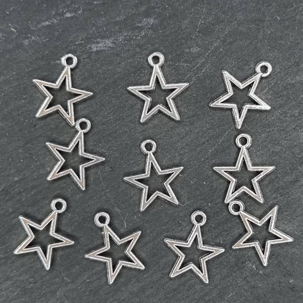 10 small silver tone star charms 