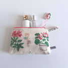 Zipped toiletries or make up bag in a vintage fabric of roses and geraniums