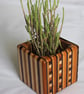 Laminated wooden pot.