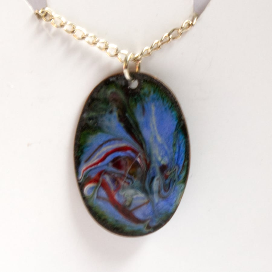 blue, white and red over dark green scrolled pendant