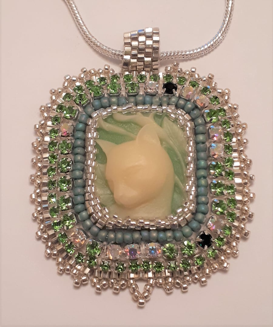 Cameo Kitty, green, bead embroidered pendant on a gold tone chain   