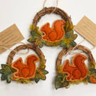 Red squirrel and leaf wreath Christmas home decoration. 