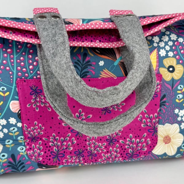Roomy purple and pink organiser bag with multiple pockets, ideal for creatives