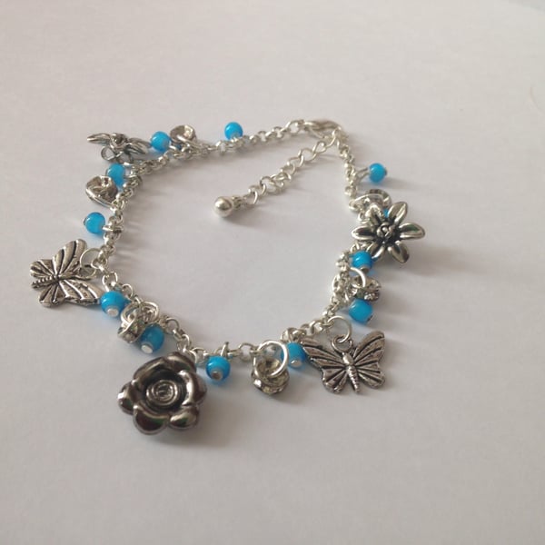 Silver plated charm bracelet with blue beads