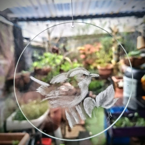 Wren engraved on a window hanging