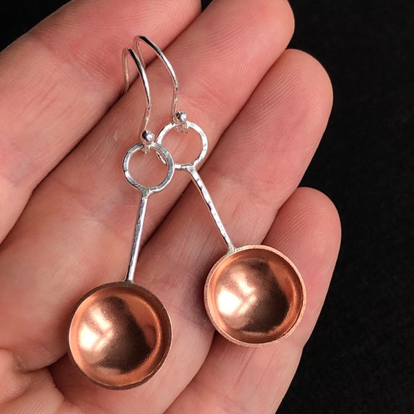 Sterling silver and copper spoon dangle earrings with hammered detail.