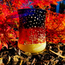 Glass painted handmade candle holder with late sunset and row of frosty trees