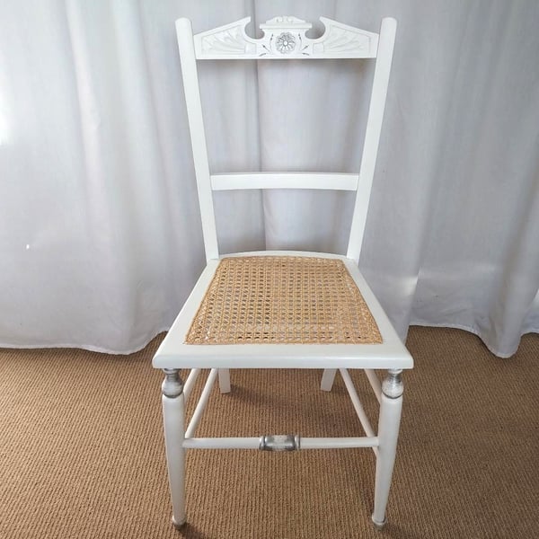 Upcycled antique chair in white chalk paint, re-caned seat.