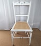 Upcycled antique chair in white chalk paint, re-caned seat.