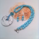 White Stone Donut Pendant on a Pale Blue beaded Necklace and Earrings, Gift Set