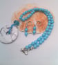 White Stone Donut Pendant on a Pale Blue beaded Necklace and Earrings, Gift Set