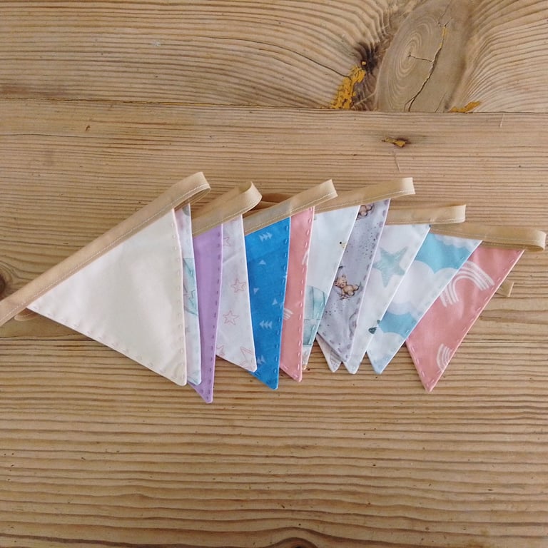 Mini bunting in muted colours ideal for a nursery decoration.