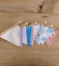 Mini bunting in muted colours ideal for a nursery decoration.