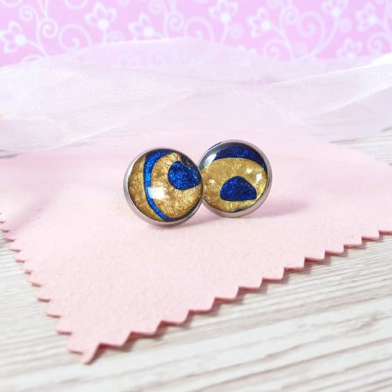 One off gold and deep blue swirl studs. Steel, metallic enamel and resin