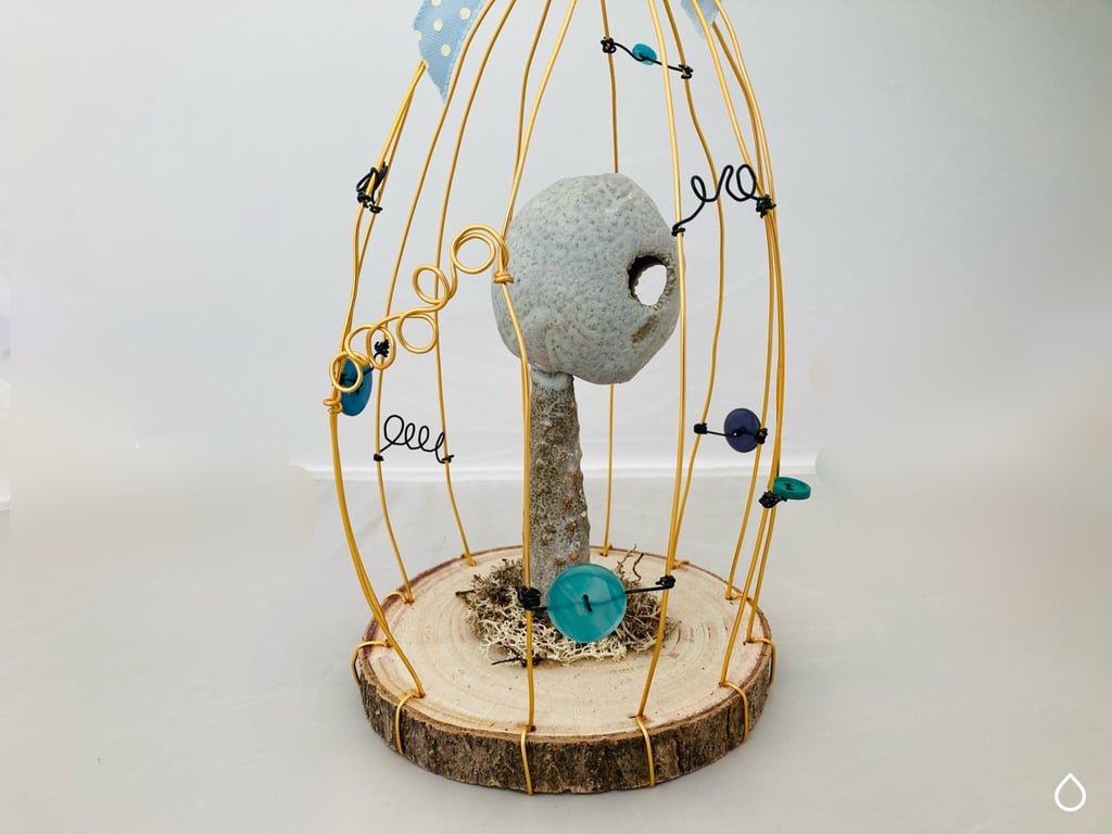 Wire bird cage with ceramic sculpture, fantasy art