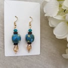 Teal dangle earrings with amber teardrop bases