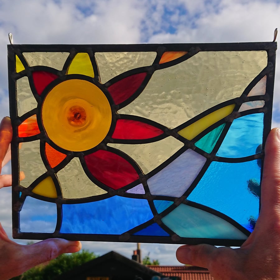 SOLD Stained glass amber-red sun and rolling wave, leaded hanging panel