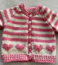 Baby’s pink and cream striped cardigan with heart motifs - Image 2