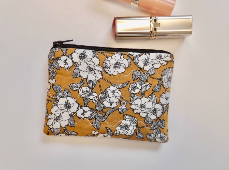 Coin purse in mustard yellow and black floral fabric