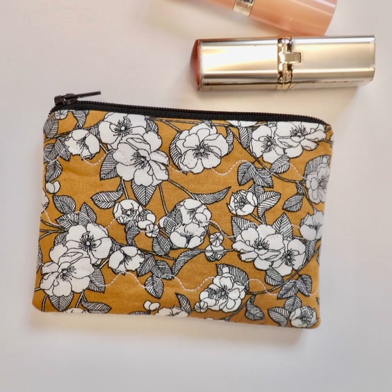 Coin purse in mustard yellow and black floral fabric