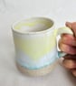 A handmade stoneware mug in yellow, green and oatmeal - Image 2