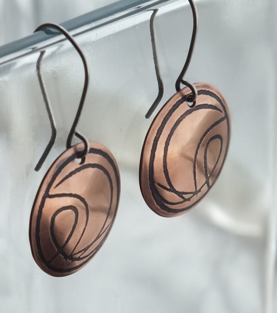 Copper disc earrings with abstract design