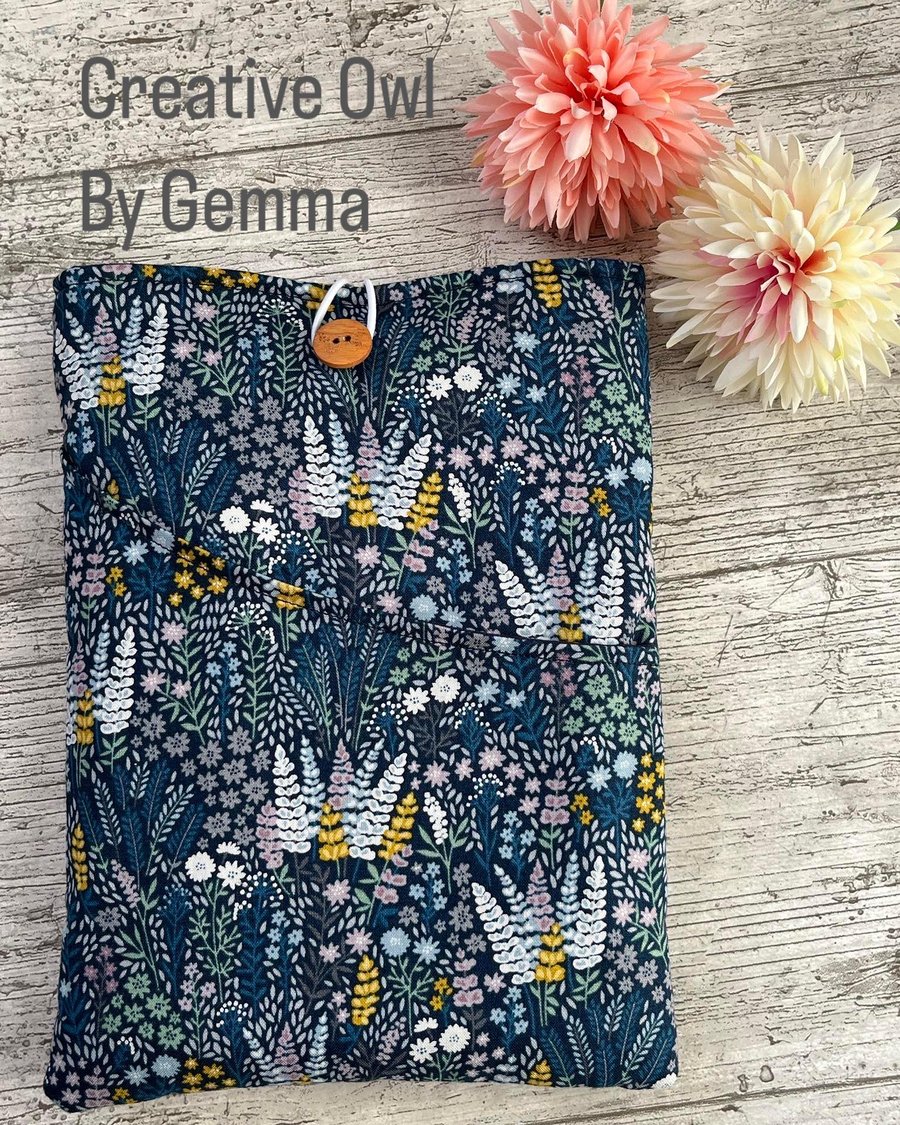 Fabric book sleeve with pocket for paperback books. Padded and fully lined. 