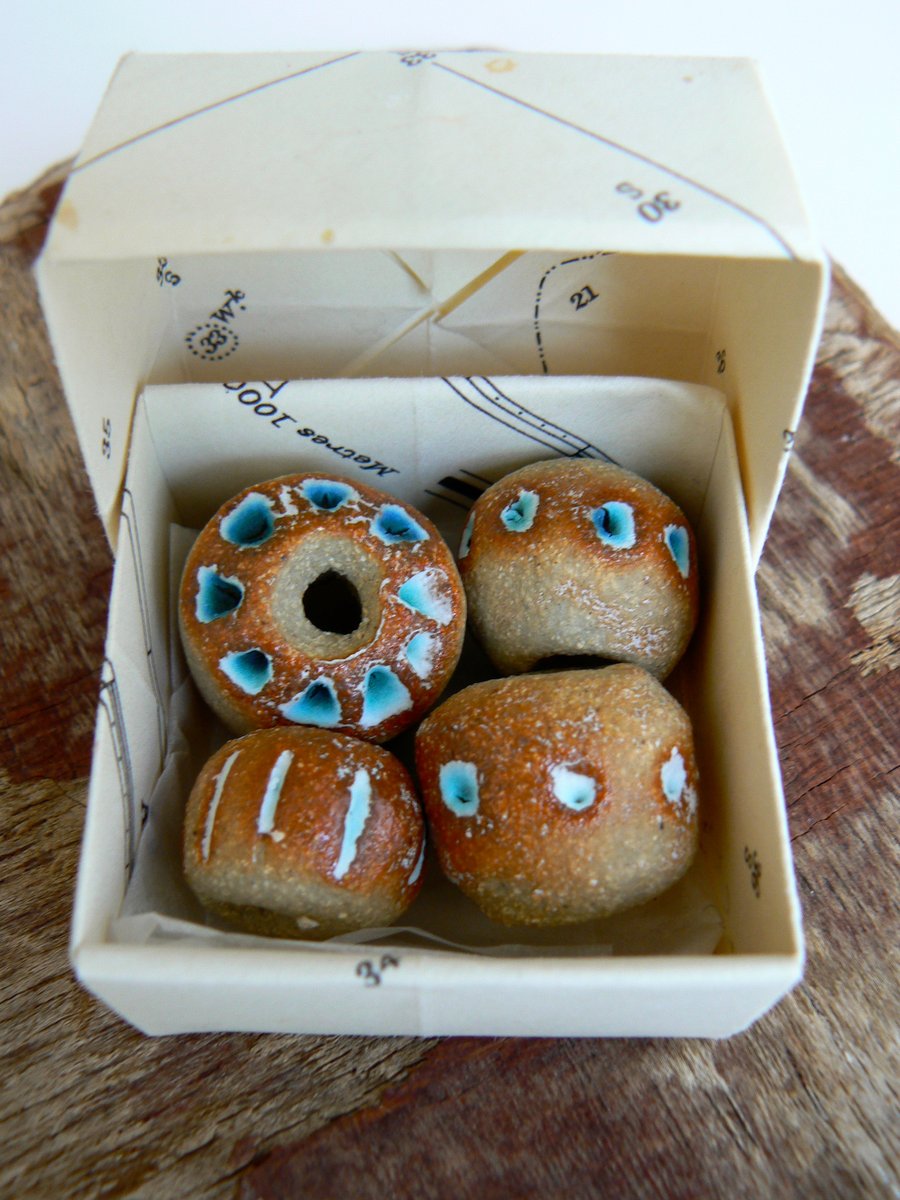 Stoneware beads with turquoise pattern.