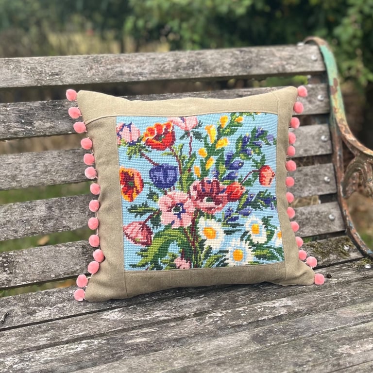 Bright floral tapestry cushion cover with reclaimed linen and pink pompoms