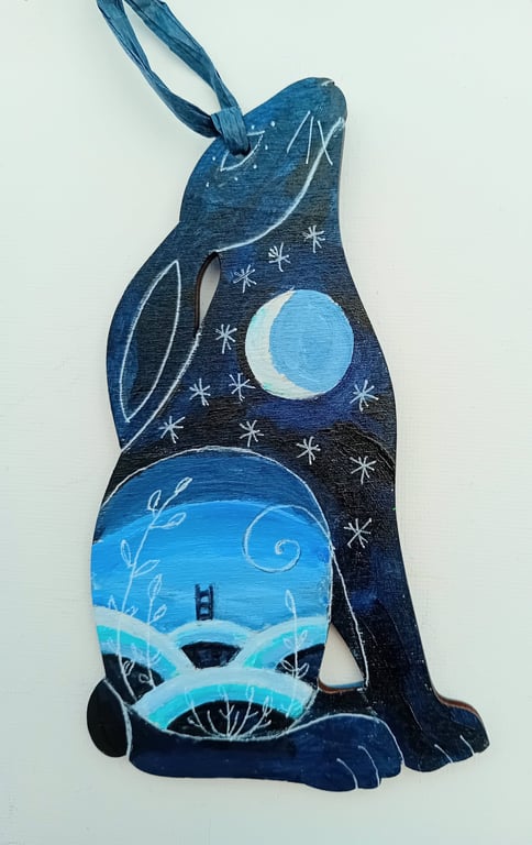Sitting hare with a blue landscape