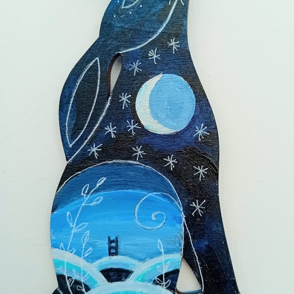 Sitting hare with a blue landscape