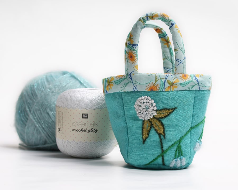 Tiny turquoise linen bag with clover and bluebell embroidery